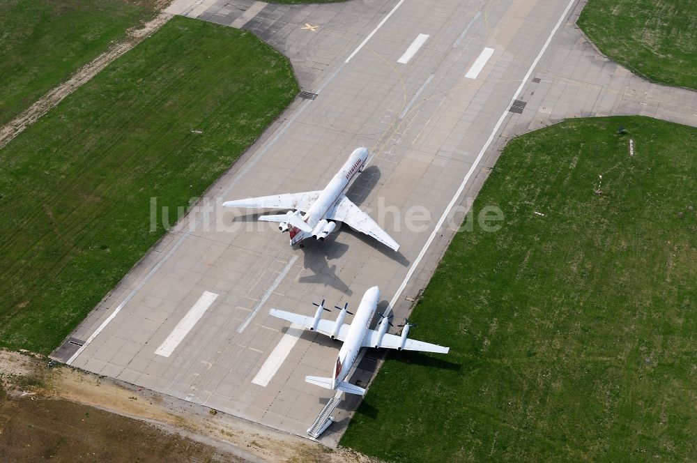 Leipzig Schkeuditz aus der Vogelperspektive: Außer Dienst gestellte Passagierflugzeuge Iljuschin IL18 und IL-62 der ehemaligen DDR- Fluggesellschaft INTERFLUG auf den resten der alten Start- und Landebahn des Flughafens Leipzig - Schkeuditz im Bundesland Sachsen