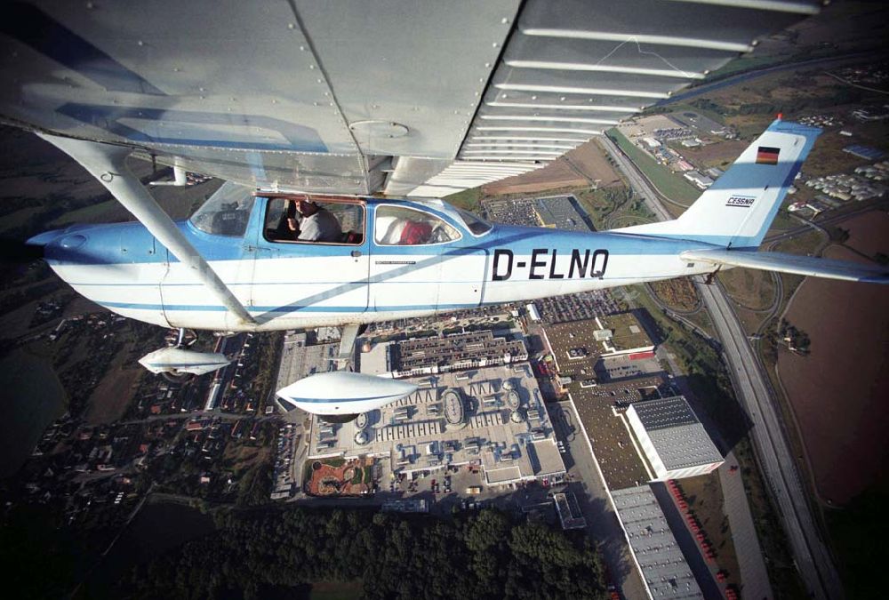 Günthersdorf von oben - Bannerschleppflugzeug Cessna 172 D-ELNQ über dem Einkaufszentrum nova eventis