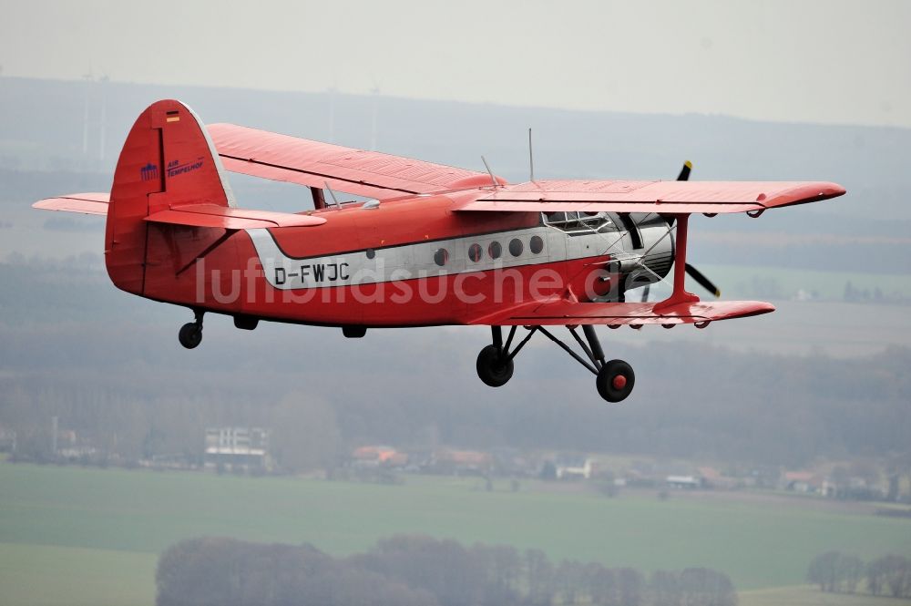 Melchow aus der Vogelperspektive: Flugzeug Antonow AN-2 mit der Kennung D-FWJC im Fluge über dem Luftraum in Melchow im Bundesland Brandenburg, Deutschland