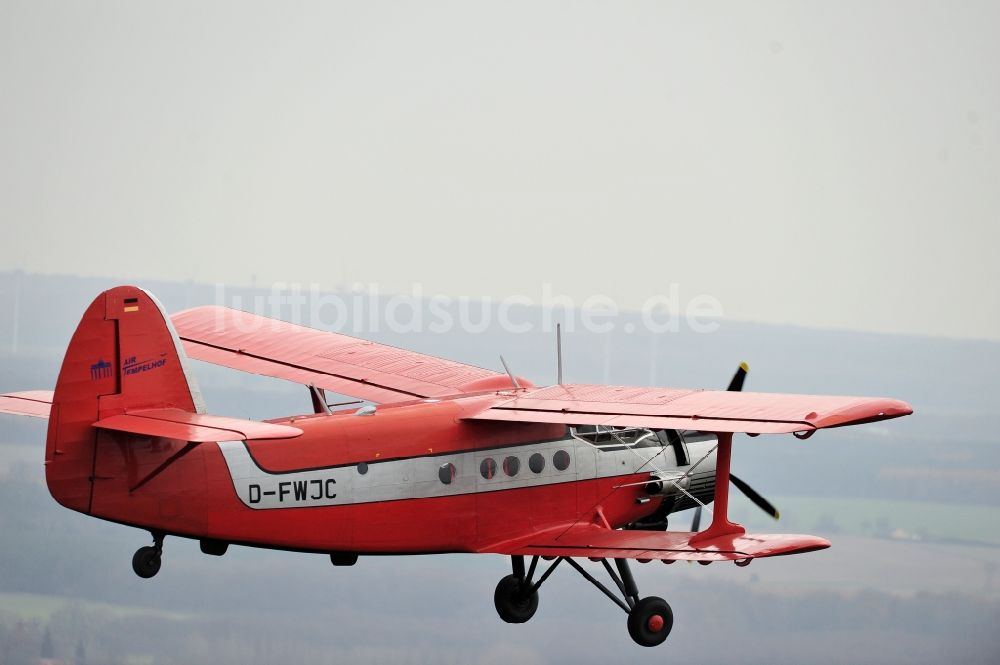 Luftbild Melchow - Flugzeug Antonow AN-2 mit der Kennung D-FWJC im Fluge über dem Luftraum in Melchow im Bundesland Brandenburg, Deutschland