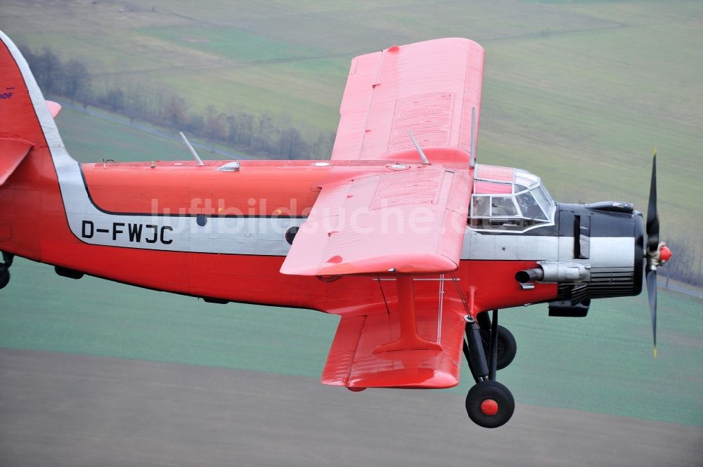 Luftbild Melchow - Flugzeug Antonow AN-2 mit der Kennung D-FWJC im Fluge über dem Luftraum in Melchow im Bundesland Brandenburg, Deutschland