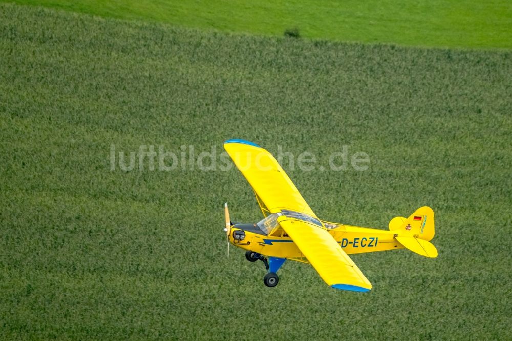 Schwelm aus der Vogelperspektive: Flugzeug Piper J-3C-85 Cub mit der Kennung D-ECZI im Fluge über dem Luftraum in Schwelm im Bundesland Nordrhein-Westfalen - NRW, Deutschland