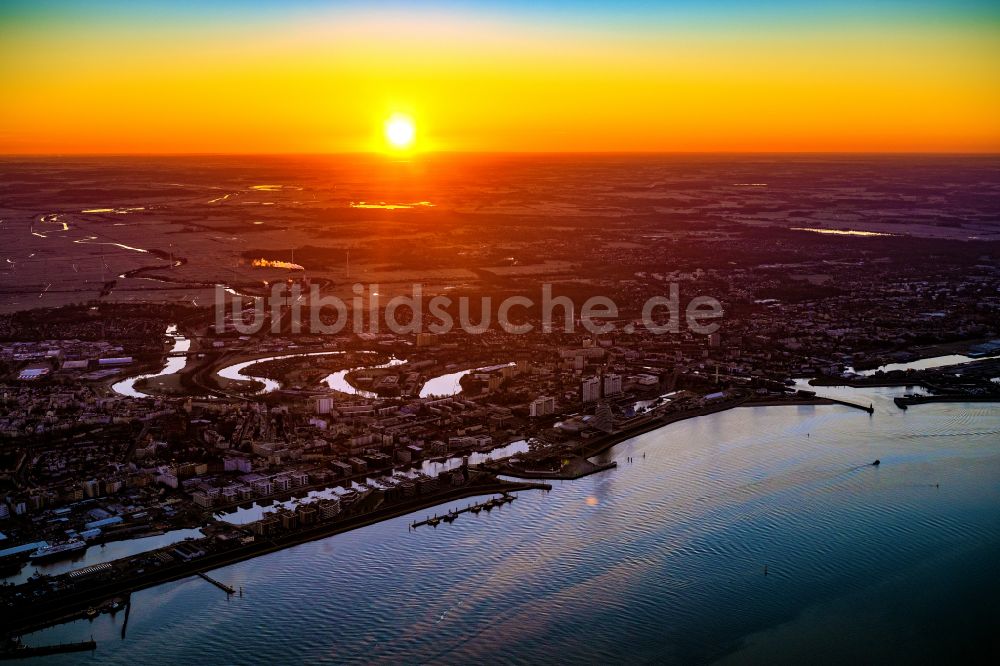 Luftbild Bremerhaven - Hafenanlagen und Terminals mit Lagerhallen, Speditions und Logistikunternehmen und vielen Containern im Sonnenaufgang im Stadtbremischen Überseehafen an der Weser- Mündung in Bremerhaven im Bundesland Bremen