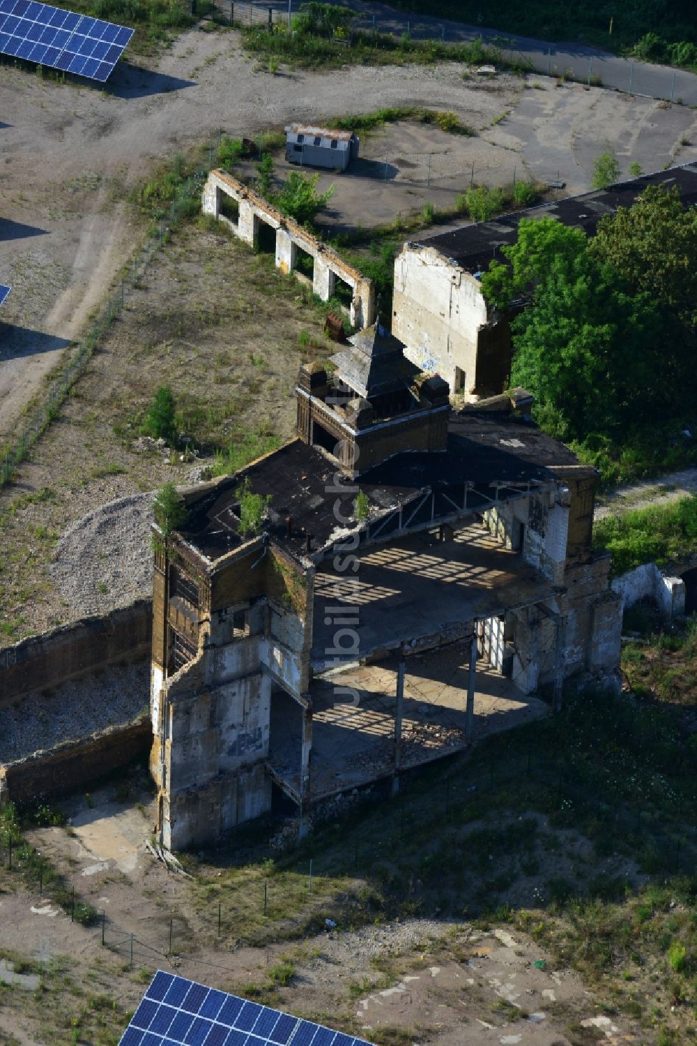 Luftaufnahme Muldenstein - Solarfelder mit Photovoltaikanlagen am Solarkraftwerk an der Fassaden- Ruine des alten Rohrwerkes Muldenstein im Bundesland Sachsen-Anhalt