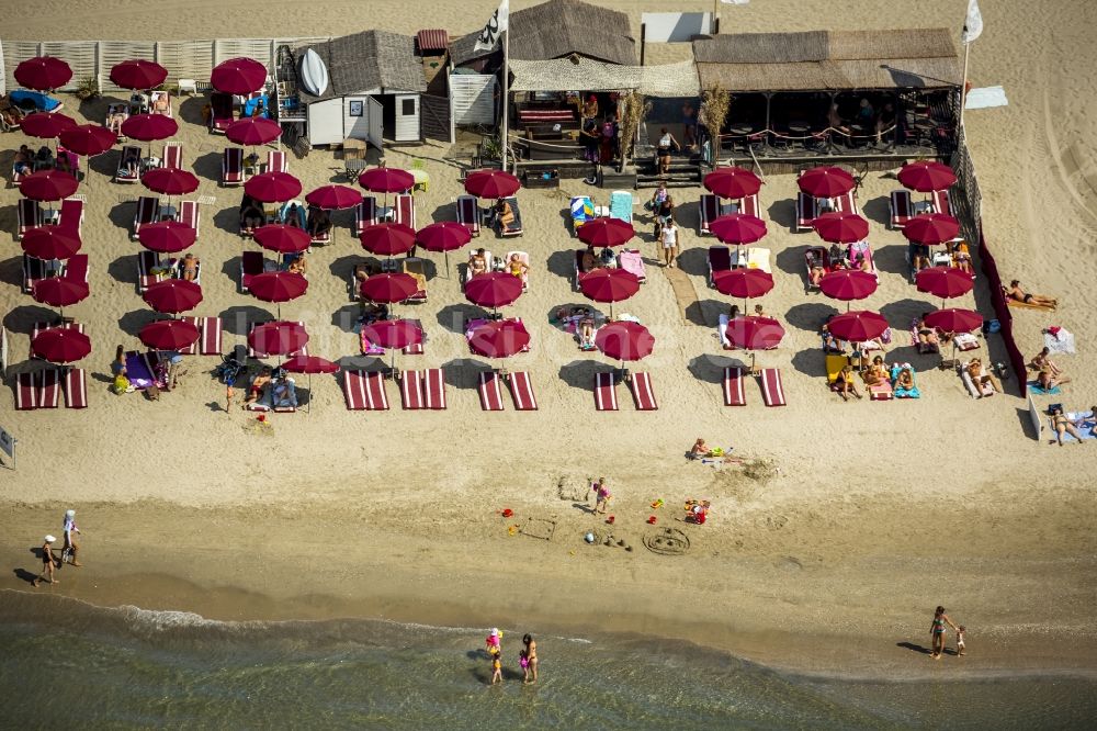 La Grande-Motte aus der Vogelperspektive: Strandliegen- Plätze und Sonnenschirmlandschaft am Sandstrand von La Grande-Motte an der Mittelmeerküste in Frankreich