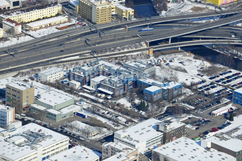 Luftbild Berlin Neukölln - Winterlich mit Schnee bedecktes Werksgelände der BIOTRONIK SE & Co. KG an der Woermannkehre in Berlin Neukölln