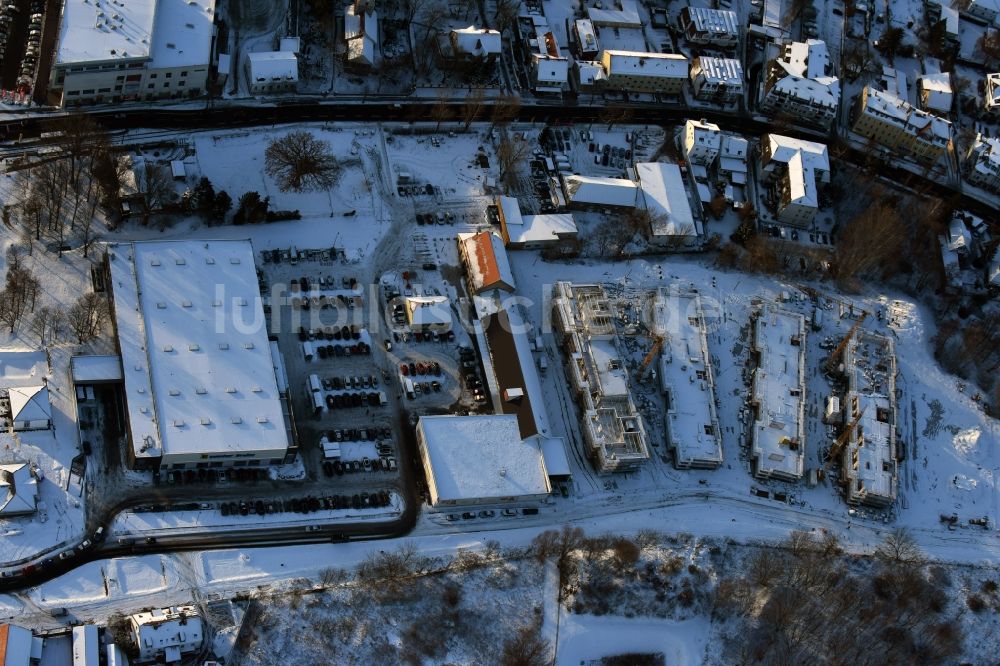 Berlin aus der Vogelperspektive: Winterlich schneebedeckte Baustelle zum Neubau einer Mehrfamilienhaus-Wohnanlage An der Schule im Stadtteil Mahlsdorf in Berlin