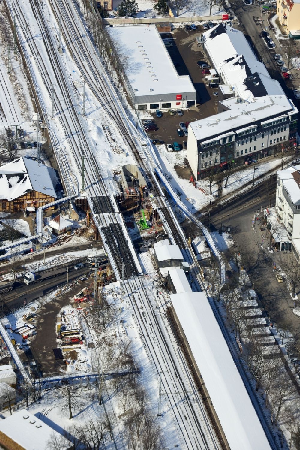 Berlin von oben - Winterlich verschneite Baustelle zum Bau der neuen Eisenbahnbrücke über die Treskowallee am S- Bahnhof Berlin - Karlshorst