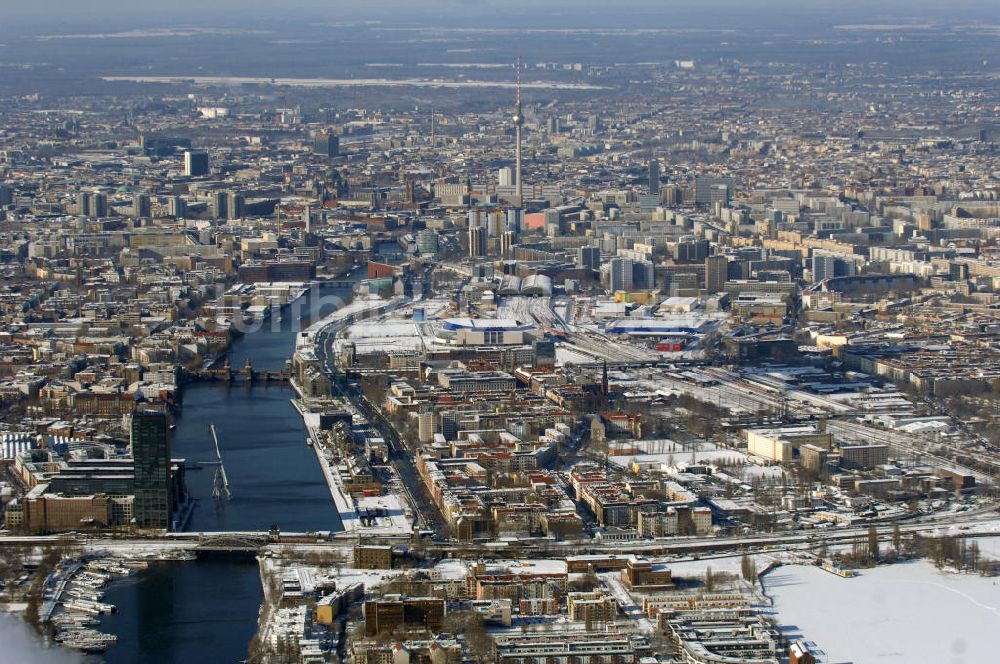 Luftaufnahme Berlin - Winterlich, verschneite Stadtansicht Berlins vom Bereich des Berliner Osthafens mit der dahinter liegenden O2 Arena im Friedrichshain